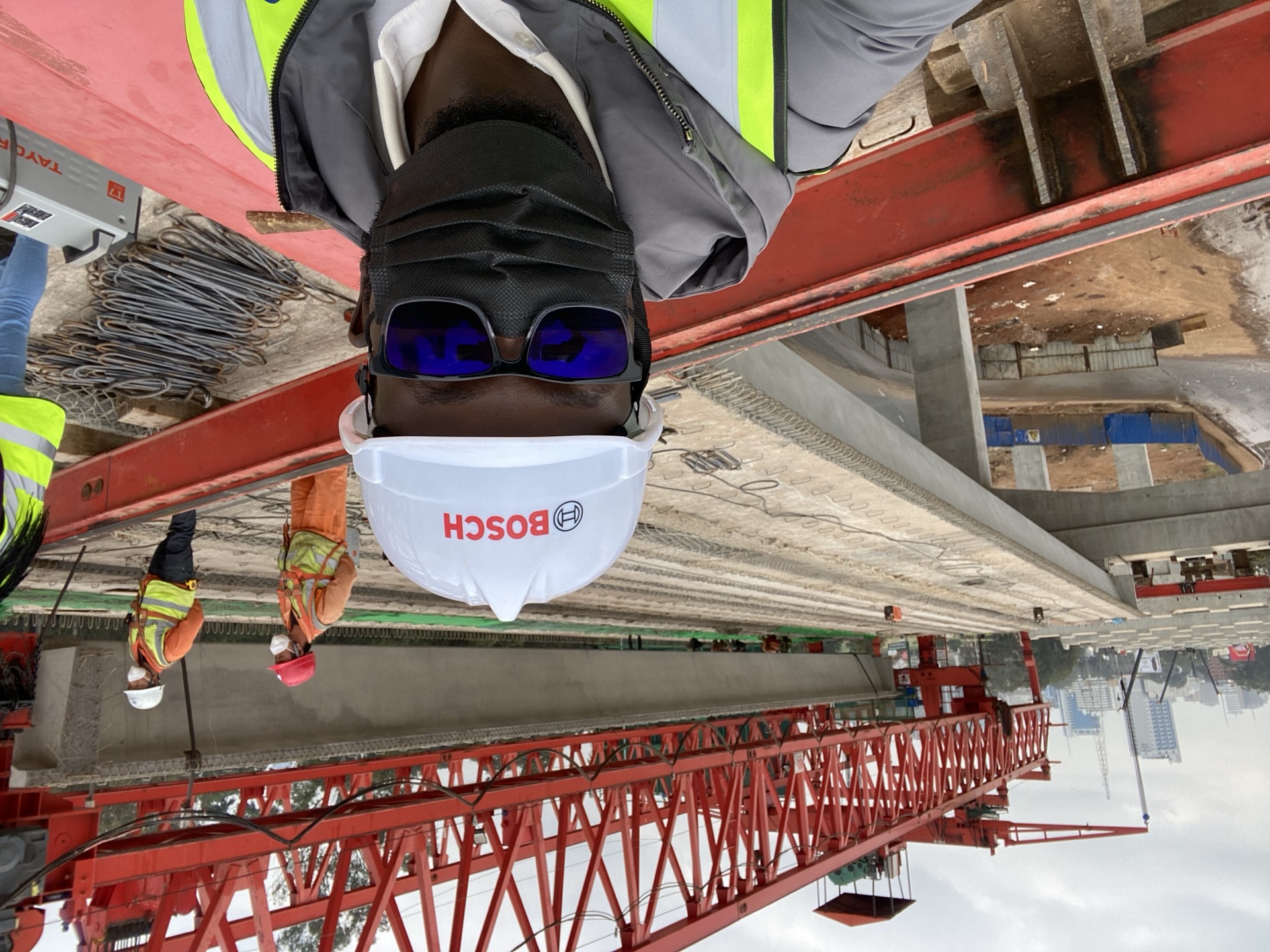 A precast concrete girder being lifted onto pier caps during Nairobi Expressway viaduct construction